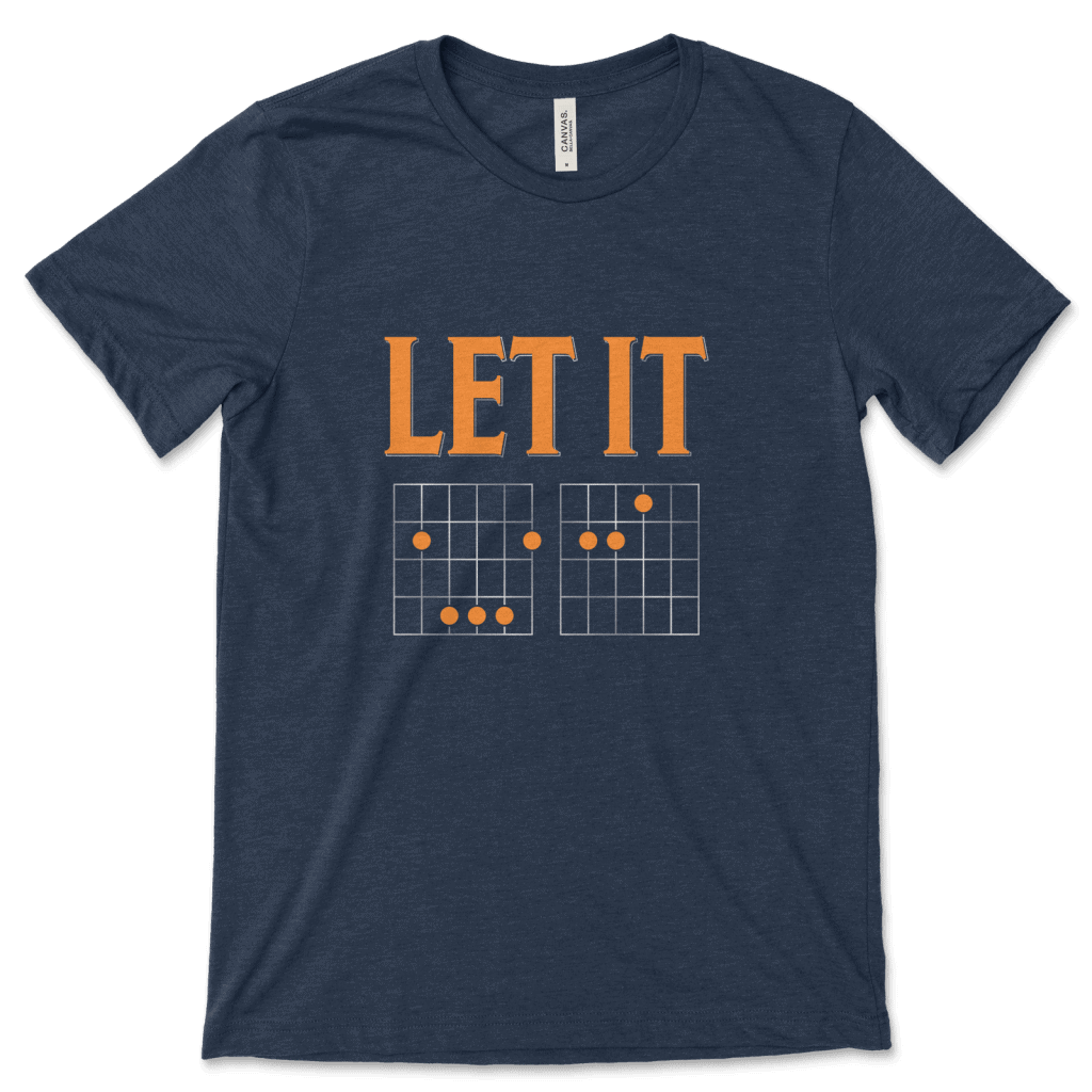 Product mockup of the witty, music-inspired Let It Be Musical Riddle print by Relateeble on a navy colored unisex/men's short sleeve tee