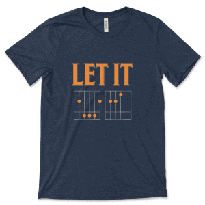 Product mockup of the witty, music-inspired Let It Be Musical Riddle print by Relateeble on a navy colored unisex/men's short sleeve tee