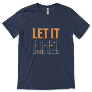 Product mockup of the witty, music-inspired Let It Be Musical Riddle print by Relateeble on a navy colored unisex/men's short sleeve tee